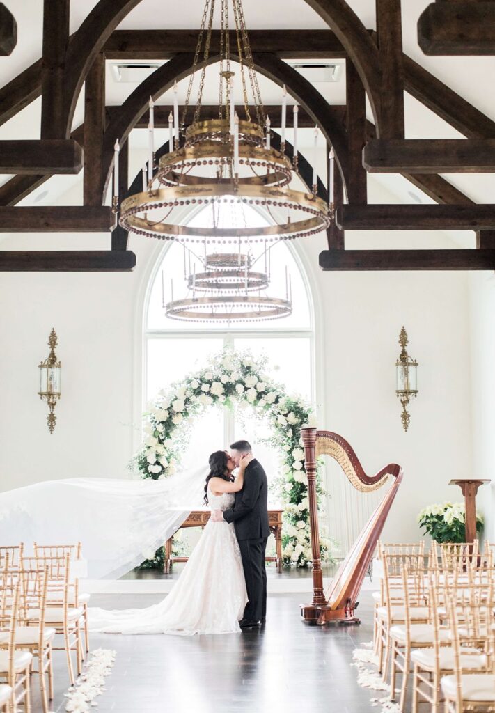 Newlyweds kissing at the ceremony location at The Park Savoy Estate.